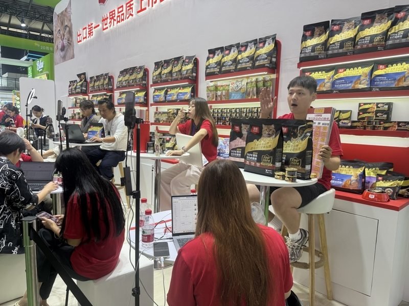 Pet food booth, where exhibitors are live-streaming to promote new products
